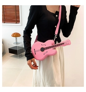 Detail shot of a creative pink guitar-shaped crossbody bag with string and sound hole patterns