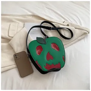 Detailed view of poison apple skull shoulder bag showing capacity with a smartphone