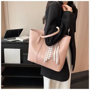 Pink commute tote bag with plaid silk scarf detail worn by a model in office setting