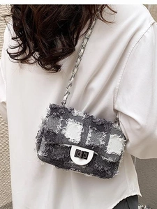 Chic quilted denim crossbody bag with frayed edges and silver twist lock closure