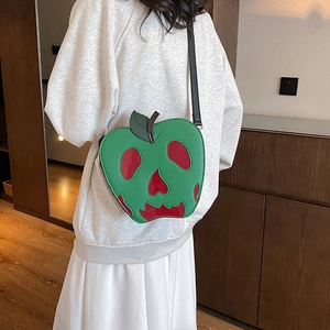 Unique apple-shaped crossbody bag with green glossy finish and red skull pattern