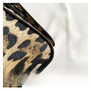 Detailed close-up of leopard print shoulder bag with cross-grain leather texture
