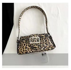 Leopard print shoulder bag size comparison with a smartphone on white background