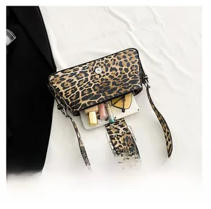 Internal capacity of leopard print shoulder bag showing phone and sunglasses inside