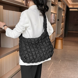 Black quilted cloud tote bag with puffy ruched texture and spacious shoulder design