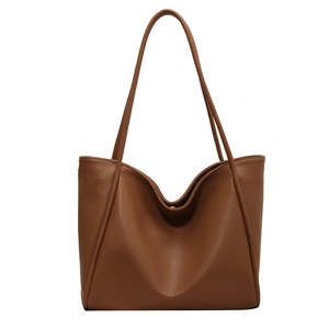 Large caramel brown pebble leather tote bag with minimalist soft structure and shoulder straps