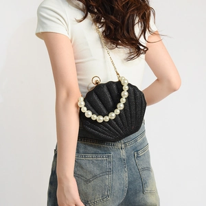 Elegant black shell evening bag with glitter finish, pearl handle and gold chain strap
