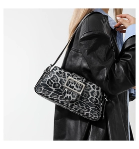 Detail of grey leopard print baguette bag featuring a square silver metal buckle and strap