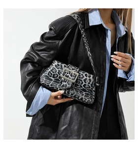 Close-up of leopard print shoulder bag with silver square buckle on model attire
