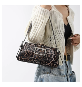Detail of leopard print shoulder bag featuring textured fabric and silver metal buckle