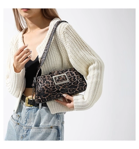 Detail shot of the animal leopard print shoulder bag with a large metallic square buckle