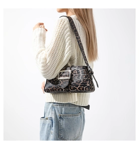 Detail of leopard print shoulder bag with a large silver metal buckle on the front