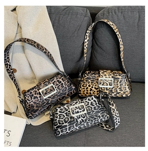 Detailed close-up of leopard print shoulder bags with glossy silver metal square buckles