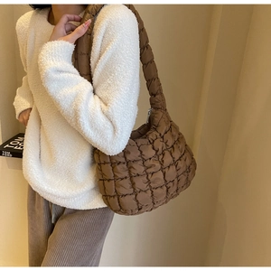 Close-up of brown quilted cloud bag with puffy grid texture and cotton-padded nylon material