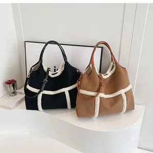 Detail of suede tote bag featuring fuzzy shearling trim and decorative buckles