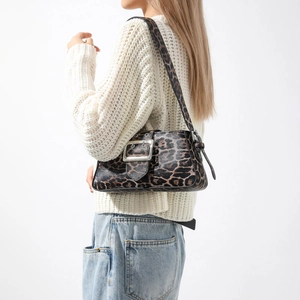 Fashionable leopard print shoulder bag with silver buckle worn with white sweater