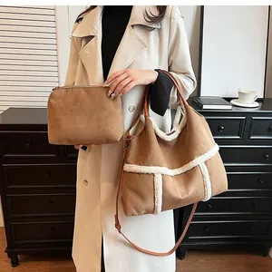 Detail of suede tote bag set with faux shearling trim and matching clutch purse