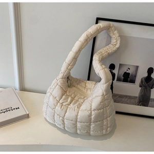 Detailed view of cream quilted cloud bag with checkerboard pattern and zipper closure