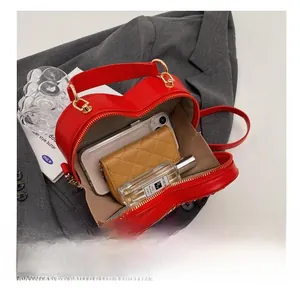 Macro detail showing the internal storage capacity for phone and wallet in a heart handbag
