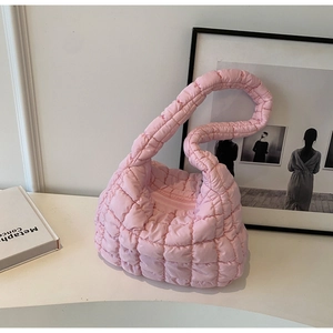 Detail of pink quilted cloud bag featuring soft puffer fabric and plaid stitching pattern