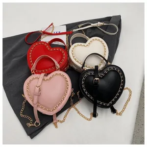 Selection of heart-shaped crossbody bags in red, white, pink and black with chain trim