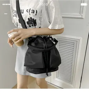 Detail of the high-density waterproof nylon fabric and drawstring closure on the bucket bag