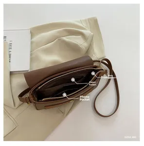Interior layout of brown leather bag showing main storage and zip pockets