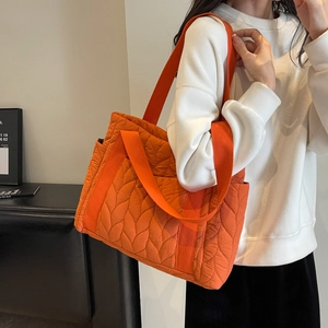 Quilted orange puffer tote bag for women with large capacity and leaf pattern stitching