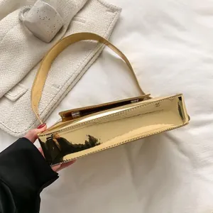Detailed close-up of glossy gold patent leather surface with bright mirror reflection
