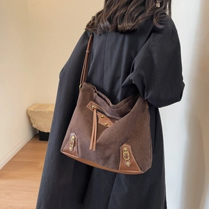 Brown corduroy hobo tote bag for women with leather trim and gold rivet details