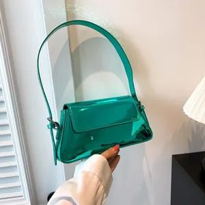Close-up of vibrant lime green patent leather baguette bag with high-gloss metallic finish