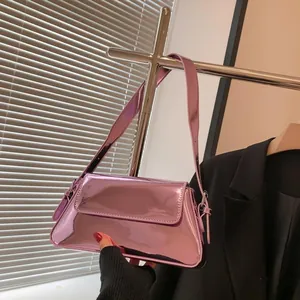 Detail view of purple mirror patent leather baguette bag with wide shoulder strap