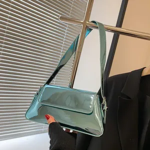 Detail of mint green baguette bag with glossy patent leather finish and mirror effect