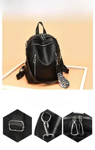 Detail showing the textured lychee leather and durable silver hardware on a black backpack