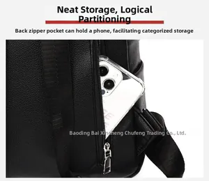 Detail of the anti-theft back zipper pocket on a black pebble leather backpack