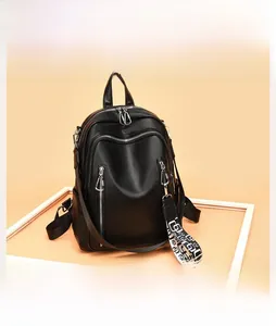 Detail of black soft leather backpack with stylish geometric patterned woven shoulder strap