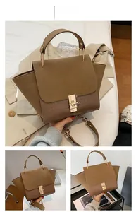 Detail of khaki color-block handbag with crocodile pattern texture and metal lock