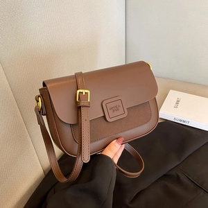 Brown leather crossbody square bag with adjustable strap and golden metal buckle