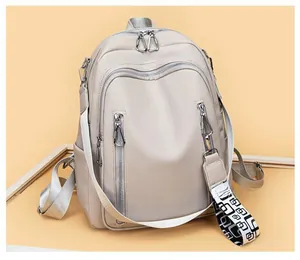 Detail view of large soft leather backpack with detachable geometric patterned shoulder strap