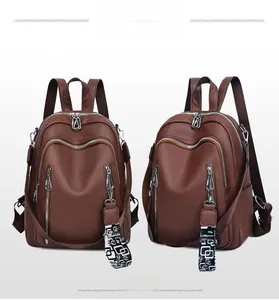 Detail of vintage brown soft leather backpack with patterned strap and side pocket view