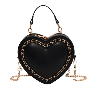 Elegant heart-shaped black handbag with gold chain trim and detachable strap for women