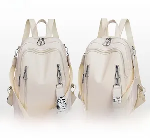 Detail of soft white PU leather backpack with silver zippers and geometric patterned strap