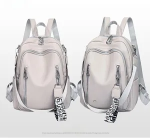Detail of off-white multi-pocket backpack with geometric patterned shoulder straps
