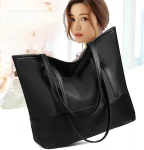 Detailed close-up showing the durable black oxford fabric texture of this tote bag