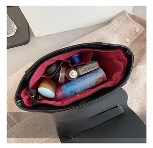Detailed view of the spacious red fabric interior with a zipper pocket and cosmetics