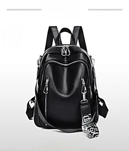 Front detail of large black leather backpack featuring multi-zipper pockets and trendy strap