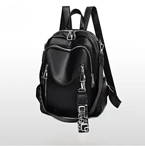 Detail of black soft leather backpack with stylish geometric patterned strap