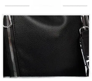 Macro shot of black litchi pattern leather texture with silver metal zipper detail