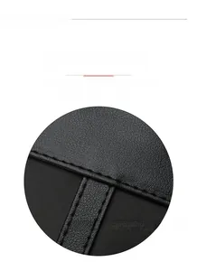 Detailed macro view of the tight stitching and lychee grain texture on black oxford tote bag