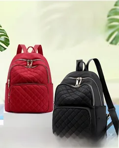 Detail of red and black quilted nylon backpacks with water-resistant fabric and zippers